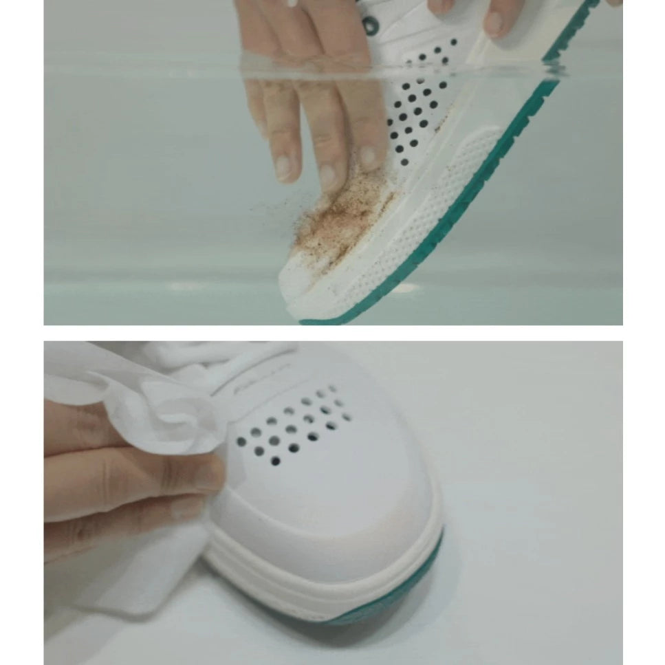 Cleaning a white shoe with a brush, showing dirt being removed.